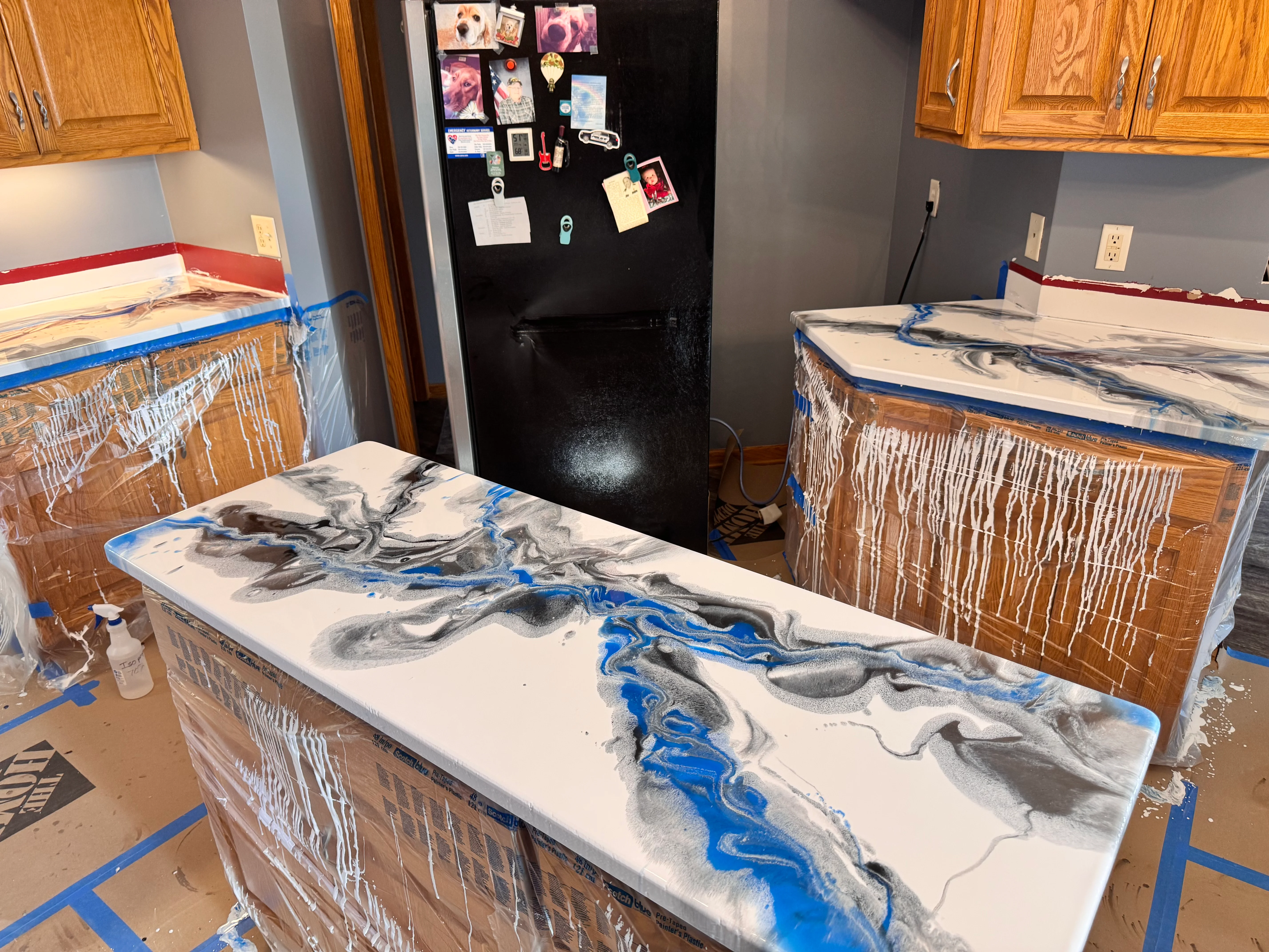 Custom epoxy countertop with blue resin veining and charcoal swirls on white base