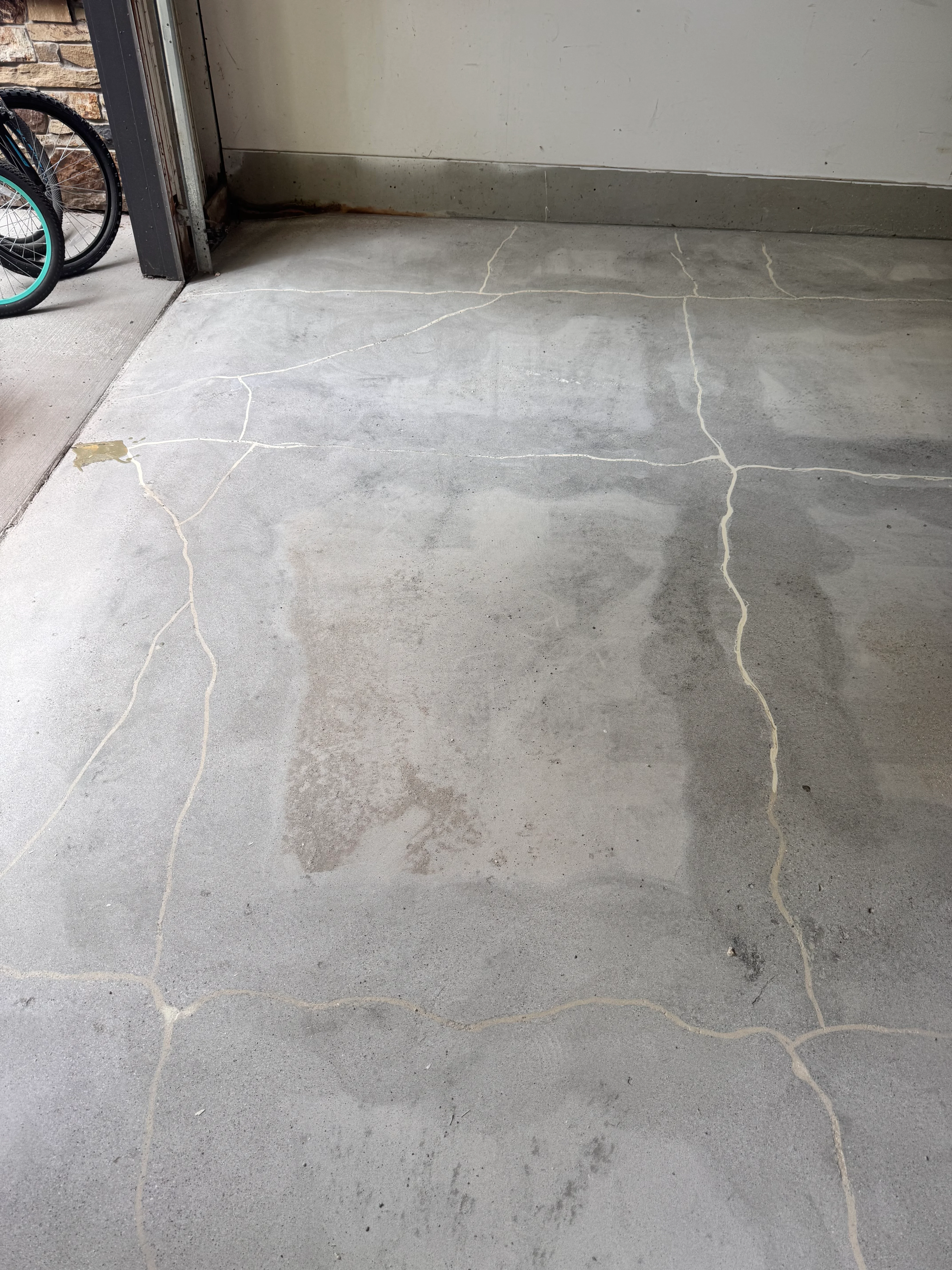 Newly installed epoxy garage floor with defined seam lines and uniform gray finish
