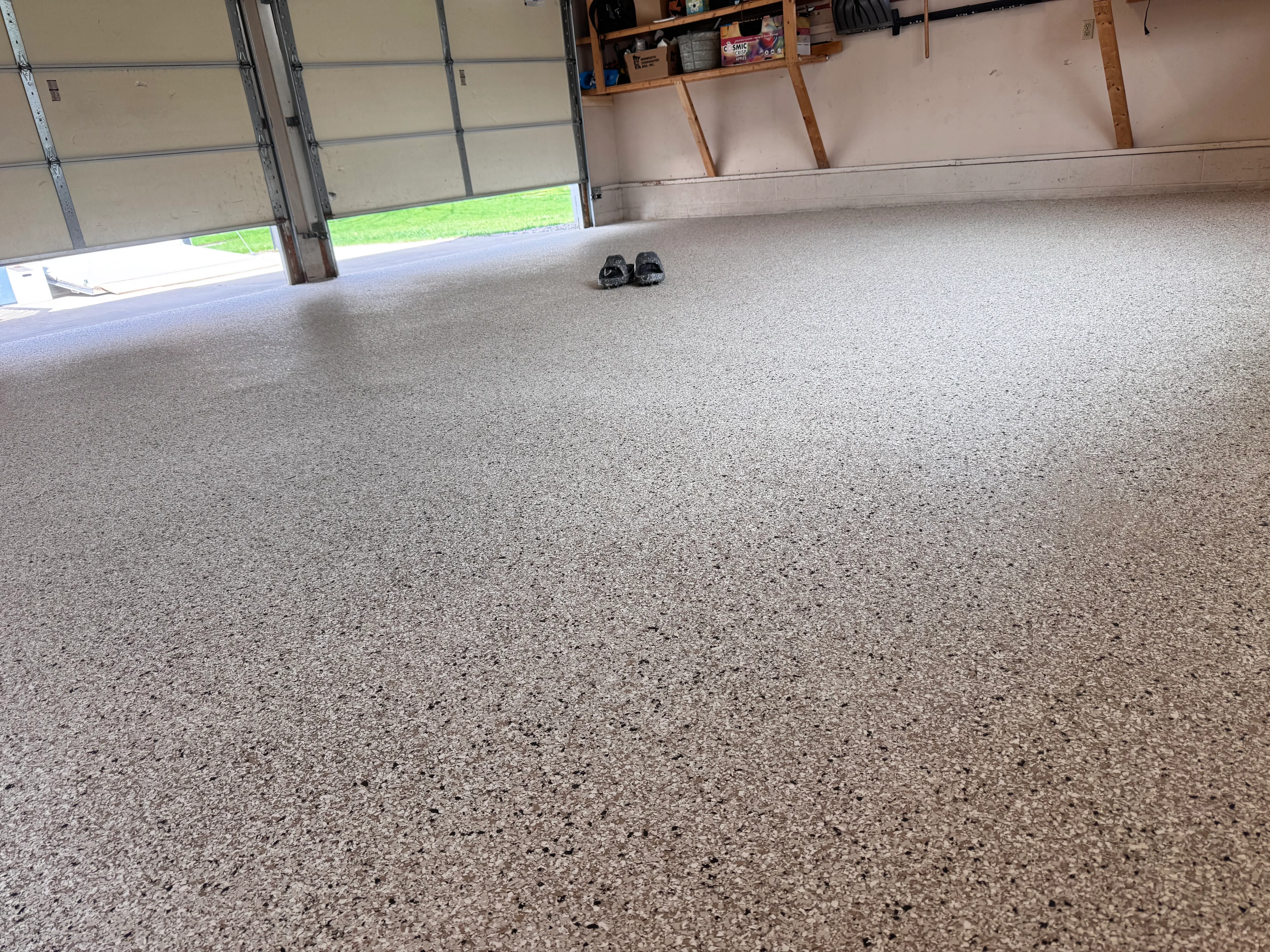 Finished gray epoxy garage floor with seamless coating and aggregate finish